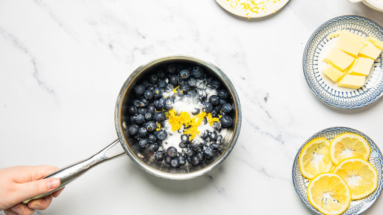 Making blueberry lemon compote.