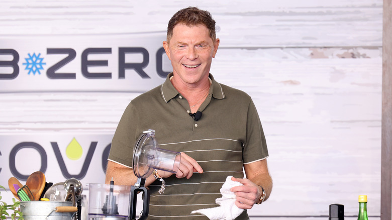 Bobby Flay cooking on stage at a demonstration
