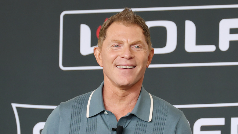 Bobby Flay smiling at a cooking event