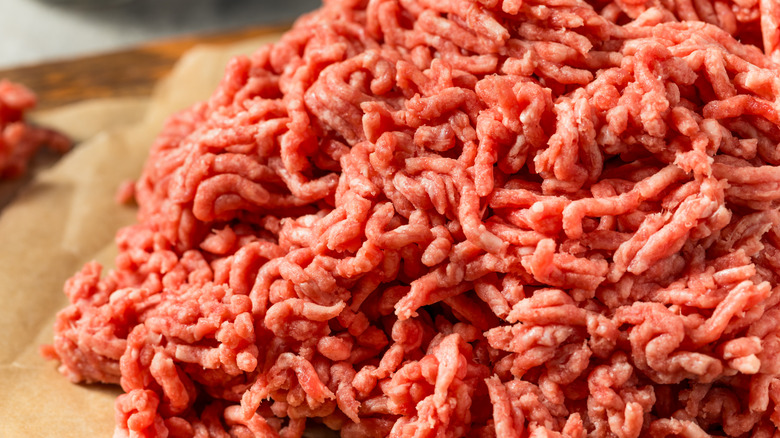 Close up of a pile of ground beef on a sheet