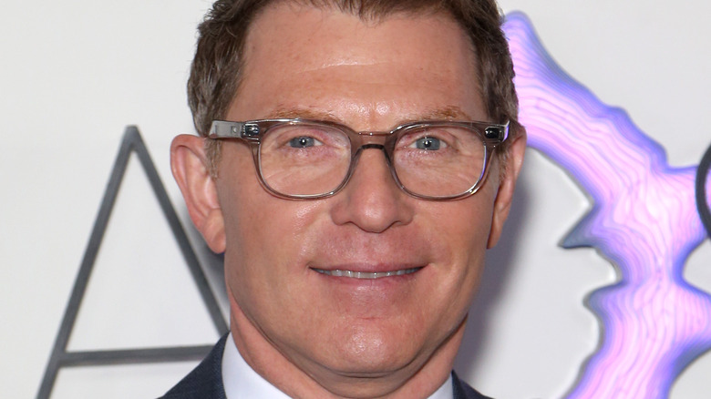 Bobby Flay wears glasses and smiles