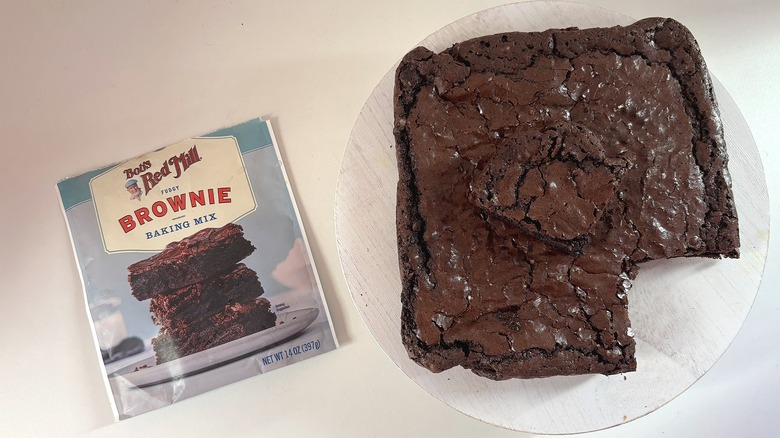 Bob's Red Mill brownie mix bag next to brownies on white table