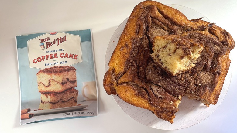 Bob's Red Mill coffee cake mix bag next to coffee cake on white table