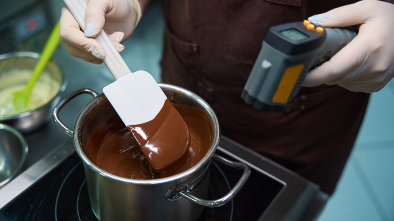 Chocolatier boiling chocolate on the stove