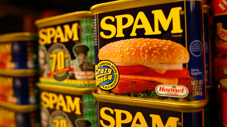 Several cans of Spam stacked on a shelf
