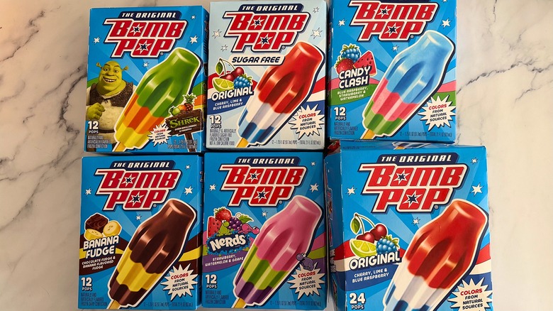 Six boxes of Bomb Pops on marble surface
