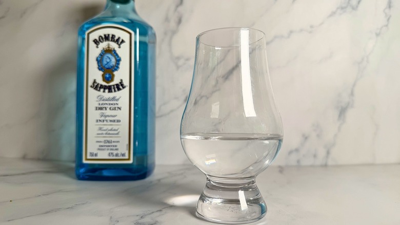 Glencairn glass with gin; bottle of Bombay Sapphire in the background