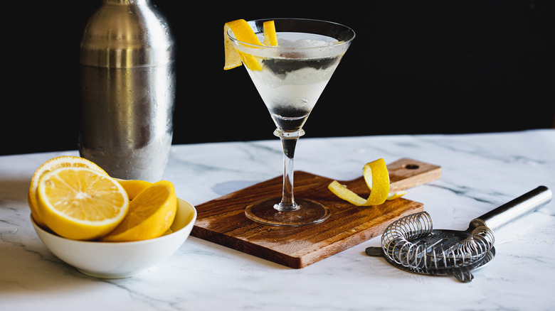 martini on cutting board with lemons
