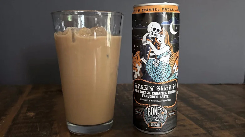 Can of Bones Coffee Co.'s Salty Siren latte next to a glass of it poured out over ice
