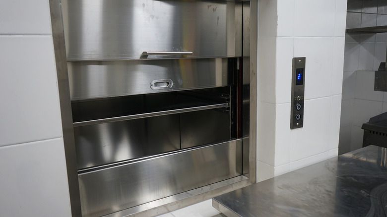 A metal dumbwaiter in an industrial kitchen