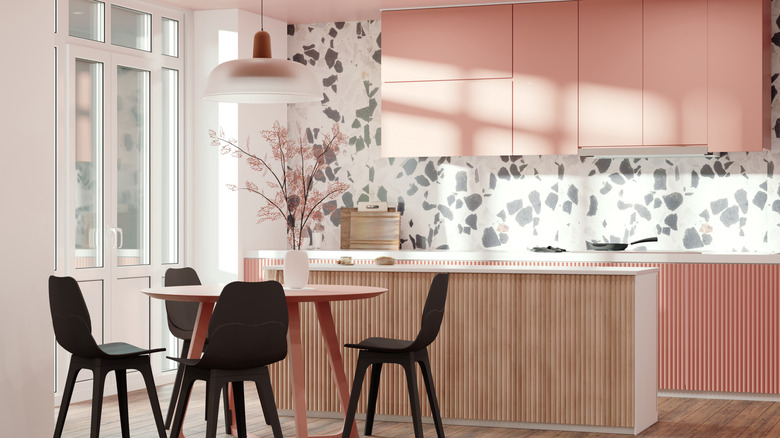 Kitchen interior design in modern style with terazzo wall and pink cabinets