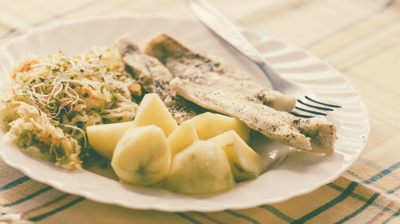 vintage fish dinner with potatoes and fork