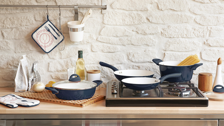 A rustic, designer-looking kitchen, with whitewashed brick located directly behind the cooktop