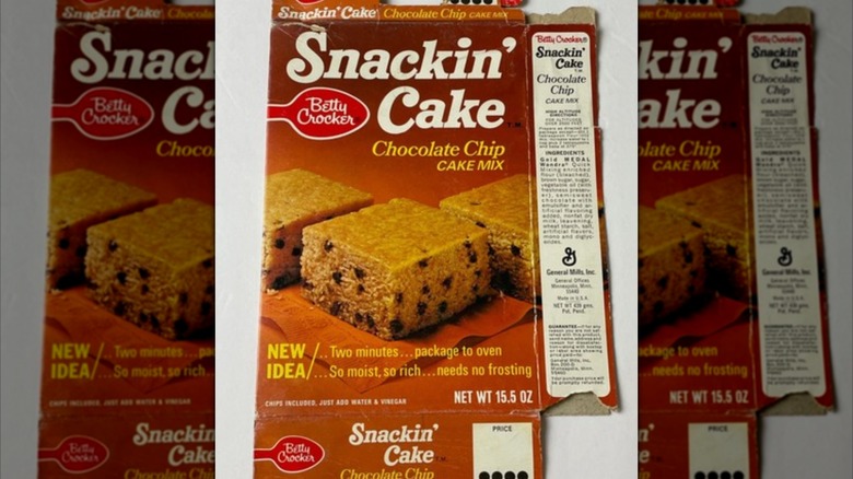 Mirrored image of flattened package of Betty Crocker Snackin' Cakes on white surface