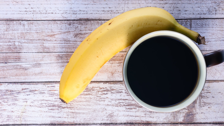banana and black coffee on table