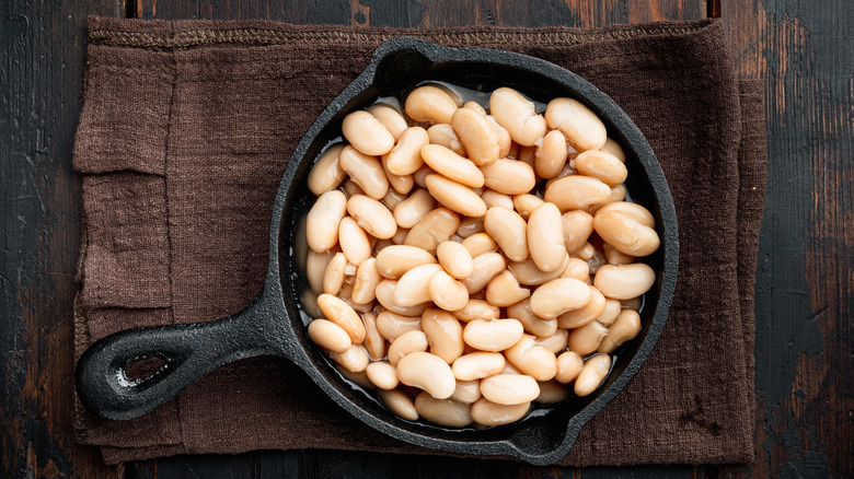 White beans in a small pan on a cloth