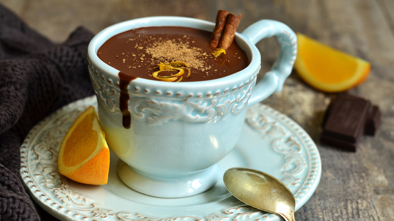 Hot chocolate cup and orange