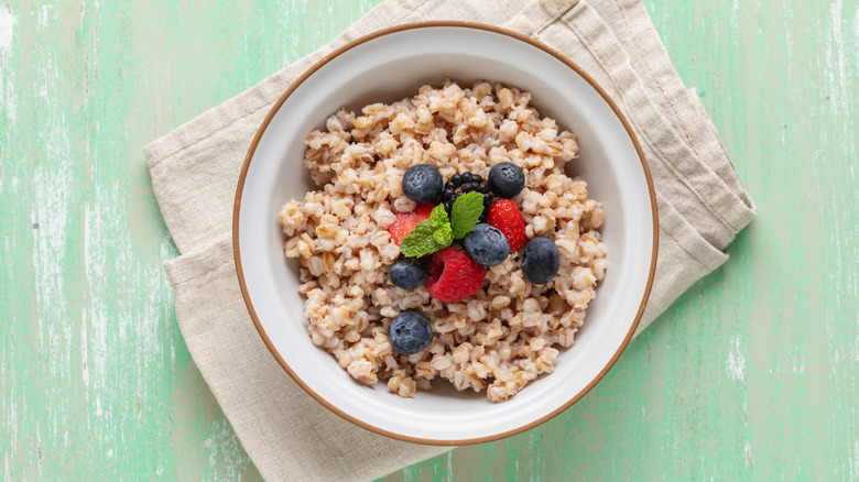Pearled barley porridge in bowl with berries
