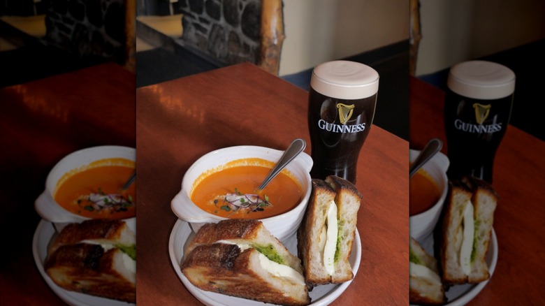 pint of Guinness with a tomato soup and a toasted mozzarella pesto sandwich