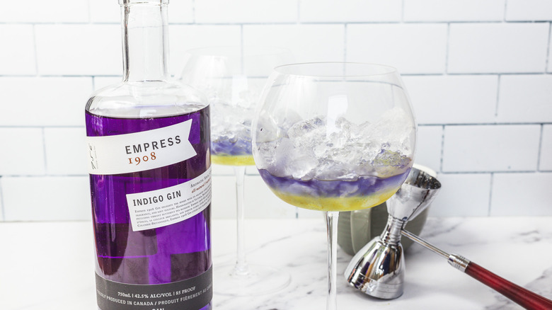 Two glasses of layered lavender spritz cocktail, with Empress 1908 gin.