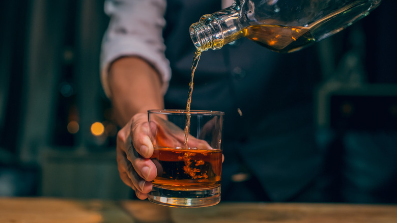 Scotch pouring into glass