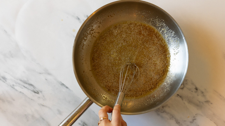 Whisking butter and sugar in pan.