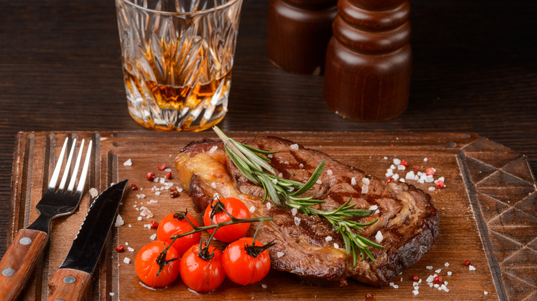 Ribeye steak with whiskey glass