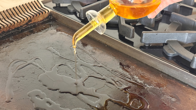 adding oil to griddle