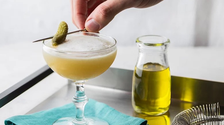 pickle cocktail alongside pickle juice