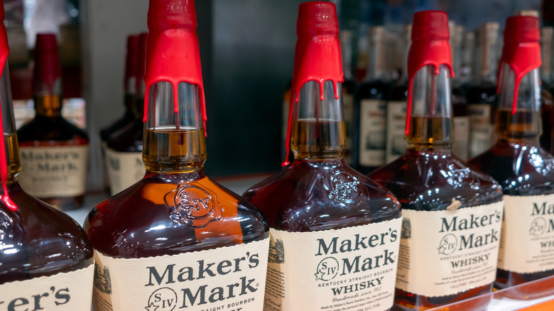 Bottles of Maker's Mark lined up on a shelf