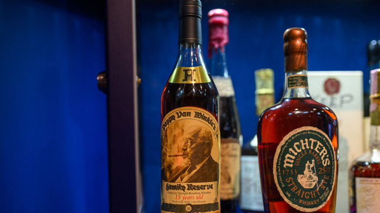 Pappy Van Winkle 15 Year displayed at auction in front of other bottles