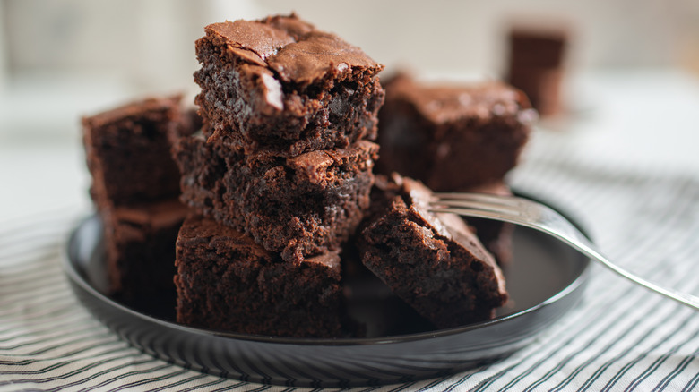 A stack of brownies on a plate