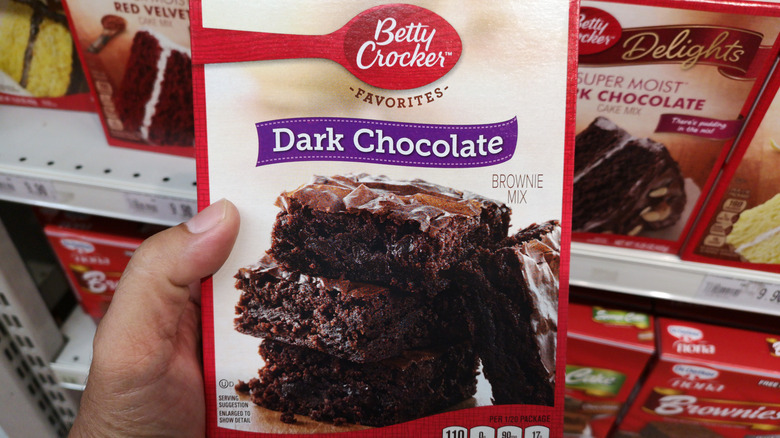 hand holding a box of brownie mix