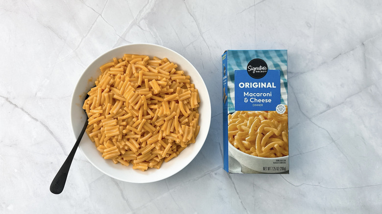 bowl of macaroni and cheese and box from Signature select