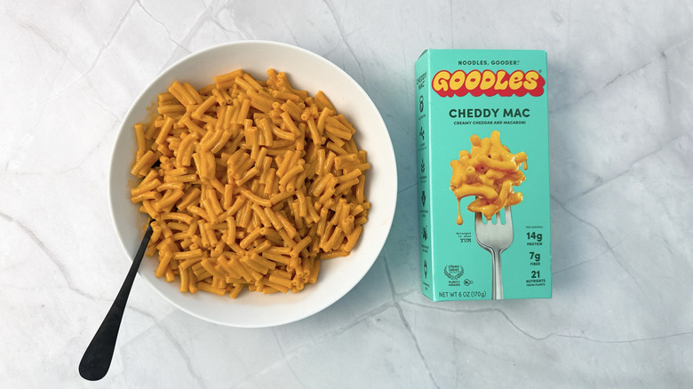 bowl of macaroni and cheese and box from goodles