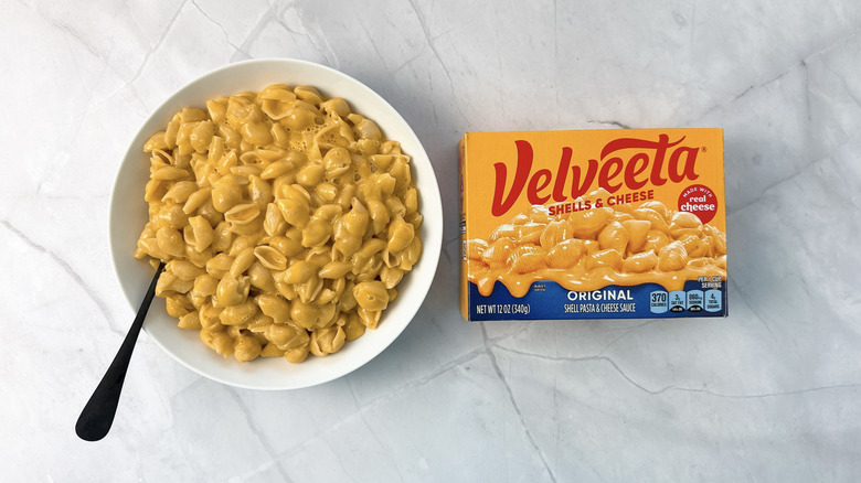 bowl of macaroni and cheese and box from velveeta