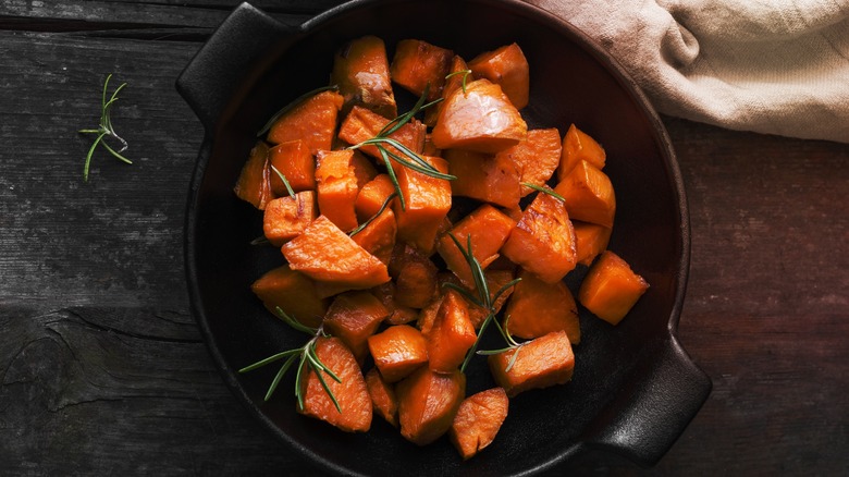 Cut sweet potatoes and rosemary in pot