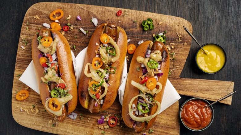Hot dogs with toppings, mustard, and ketchup