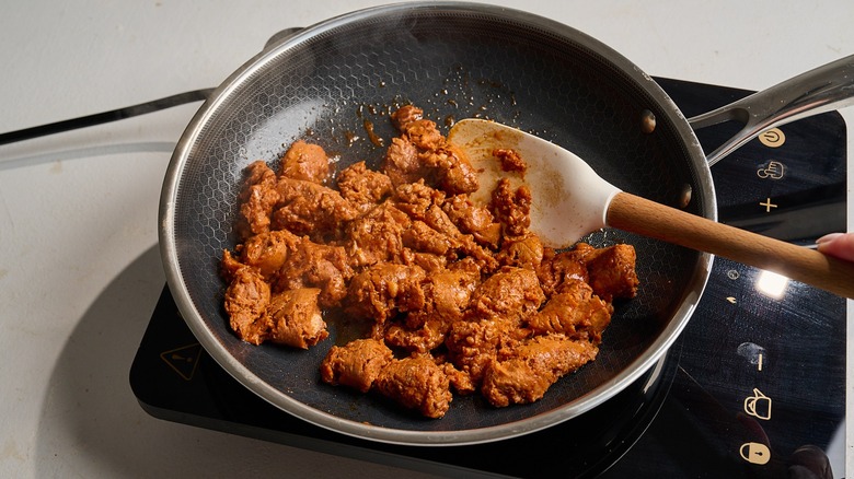 crumbling chorizo in a skillet
