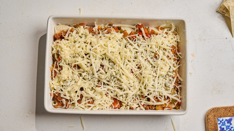 casserole dish filled with breakfast burrito ingredients