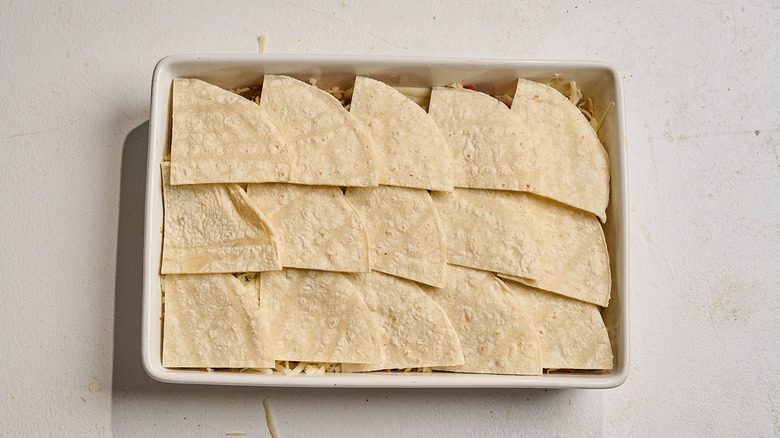 tortillas arranged across the top of the casserole dish