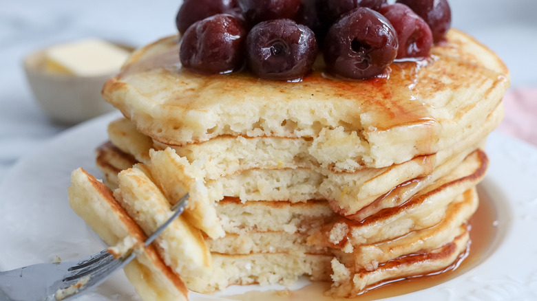 stacked lemon pancakes with cherries