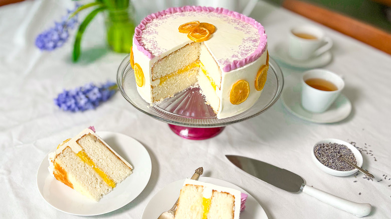 Bright and sunny lemon lavender cake with cut slices on plates and tea cups