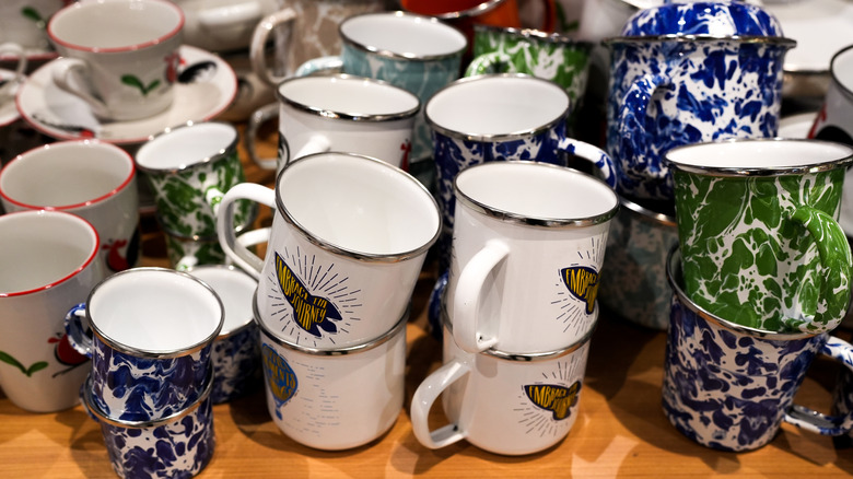 Several coffee mugs on a shelf
