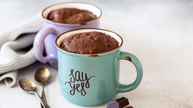 Two chocolate mug cakes with spoons