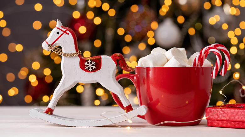 A mug with candy canes and marshmallows