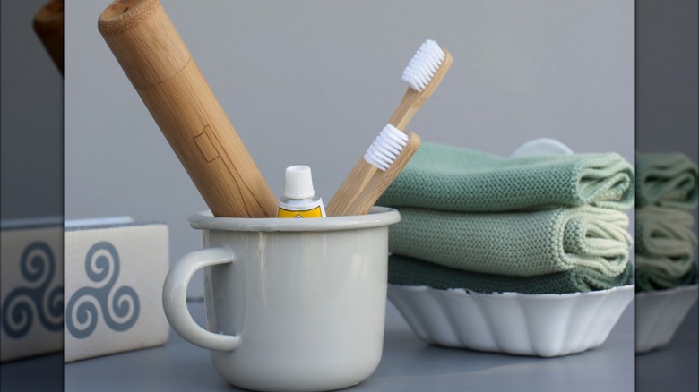 A mug holding toiletries in the bathroom