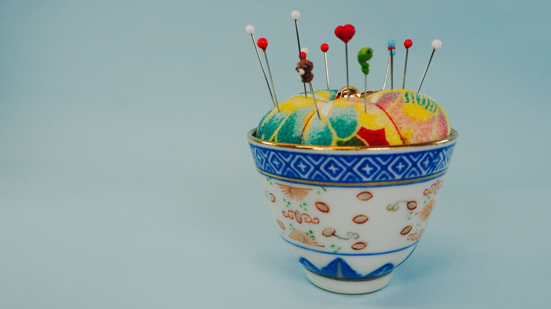A tea cup pin cushion