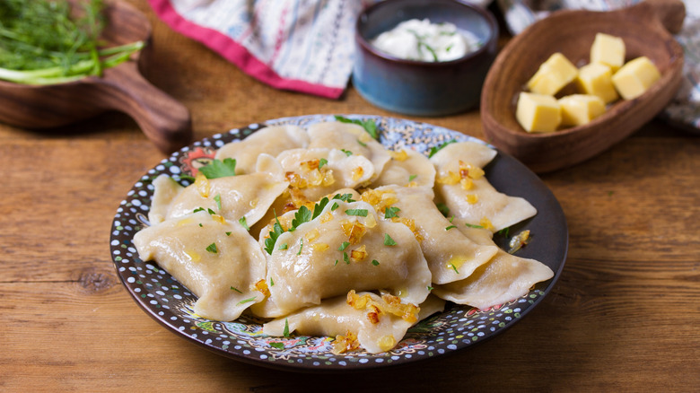 pierogi on a plate topped with herbs