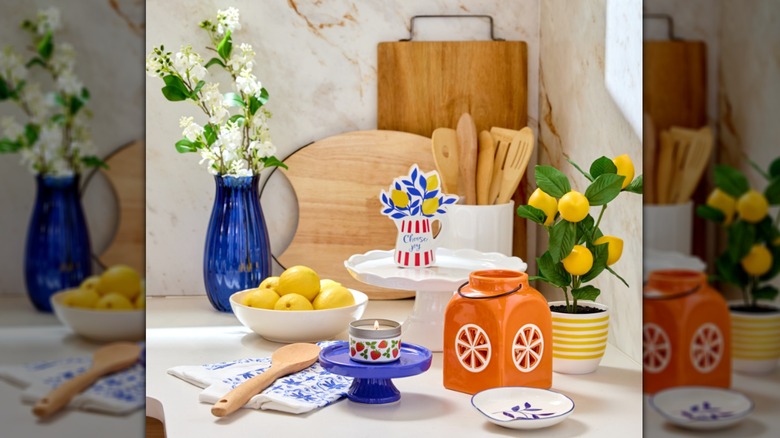 Assorted blue and yellow citrus-themed kitchenware items on counter next to lemons